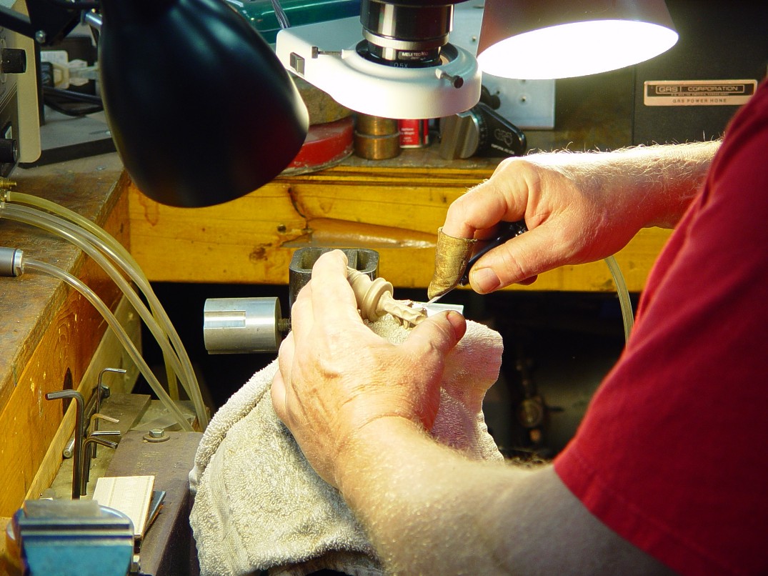 Hand-engraving cast bronze pommel made in-house Hand-engraving cast bronze pommel made in-house
