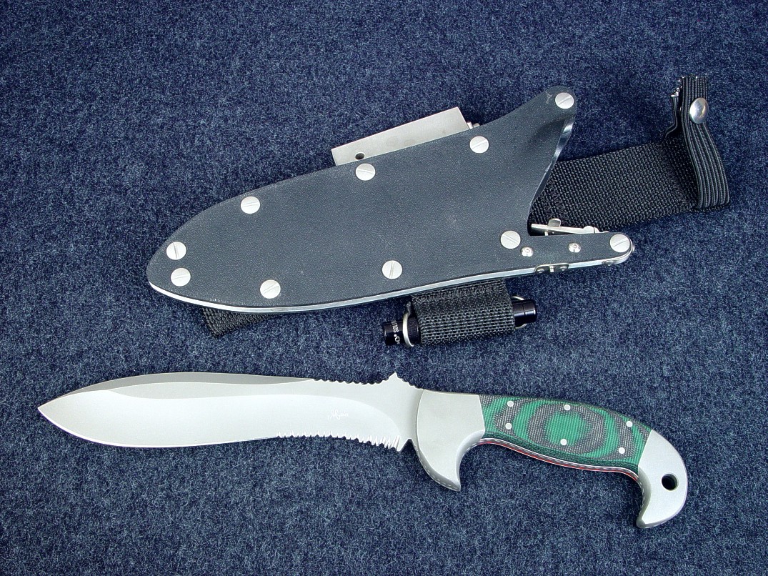 "Hania" obverse side view in ATS-34 high molybdenum stainless steel blade, 304 stainless steel bolsters, canvas reinforced green, black Micarta phenolic, locking sheath in kydex, aluminum, stainless steel with accessories "Hania" obverse side view in ATS-34 high molybdenum stainless steel blade, 304 stainless steel bolsters, canvas reinforced green, black Micarta phenolic, locking sheath in kydex, aluminum, stainless steel with accessories