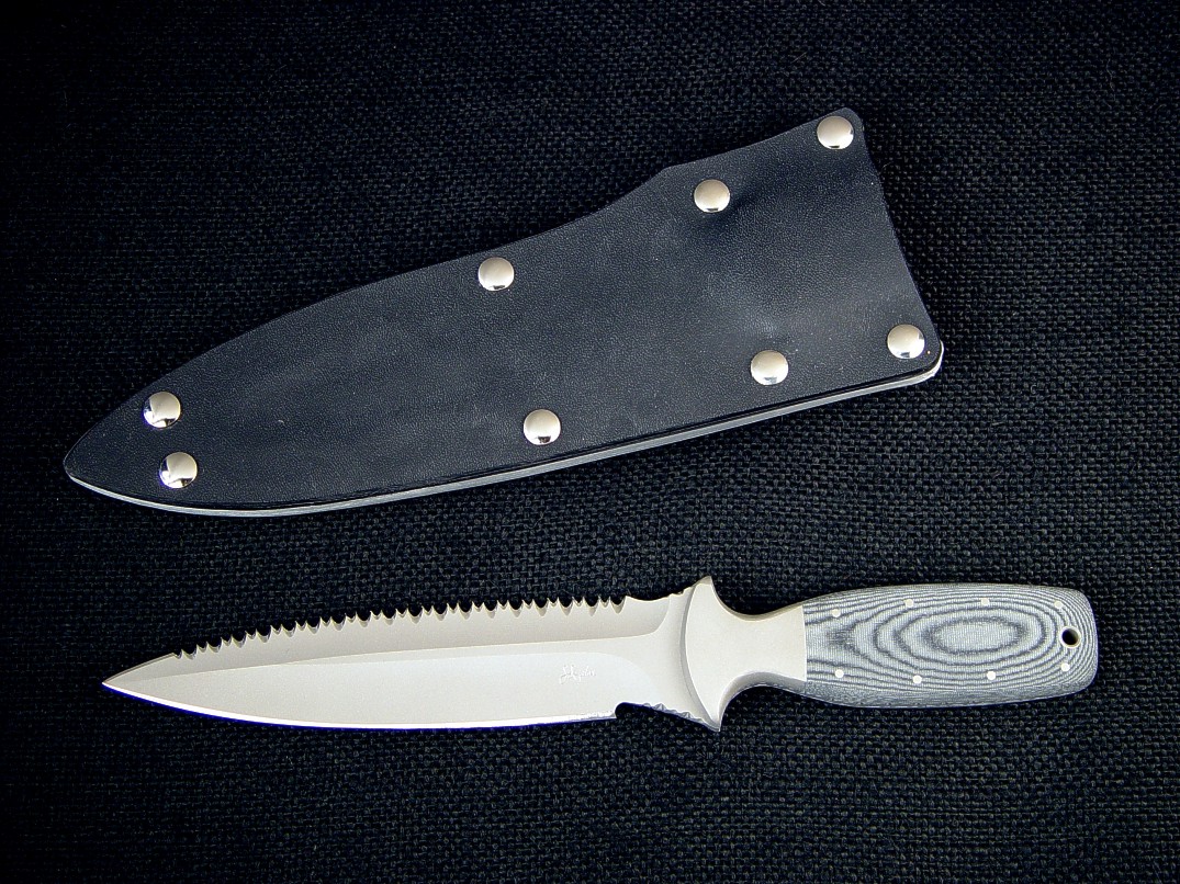 "Vampire" Rip Tooth Serrations; "Lynx" combat, tactcal, CSAR knife, obverse side view: 440C high chromium stainless steel blade, 304 stainless steel bolsters, Micarta phenolic handle, kydex, aluminum, nickel plated steel sheath "Vampire" Rip Tooth Serrations; "Lynx" combat, tactcal, CSAR knife, obverse side view: 440C high chromium stainless steel blade, 304 stainless steel bolsters, Micarta phenolic handle, kydex, aluminum, nickel plated steel sheath