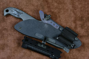 "Contego" Counterterrorism Tactical Knife, sheathed view, HULA with LIMA mounted, in T3 cryogenically treated CPM154CM  powder metal technology high molybdenum martensitic stainless steel blade, 304 stainless steel bolsters, Black/Gray G10 fiberglass/epoxy composite handle, hybrid tension tab-locking sheath in kydex, anodized aluminum, stainless steel, titanium