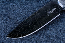 "Thuban" obverse side blade detail. This is a five power enlargement of th blade detail. The black is blued 1095 carbon steel, the bright lines are 200 series nickel "Thuban" obverse side blade detail. This is a five power enlargement of th blade detail. The black is blued 1095 carbon steel, the bright lines are 200 series nickel