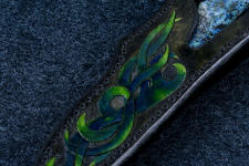 "Thuban" sheath front carving detail. This is a 3 power enlargement. Sheath carvig has natural finish in cuts for contrast between hand-dyed pattern and background. "Thuban" sheath front carving detail. This is a 3 power enlargement. Sheath carvig has natural finish in cuts for contrast between hand-dyed pattern and background.